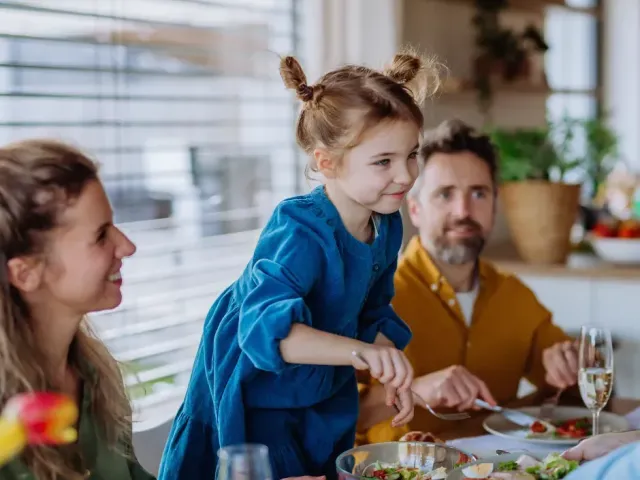kind met ouders aan tafel